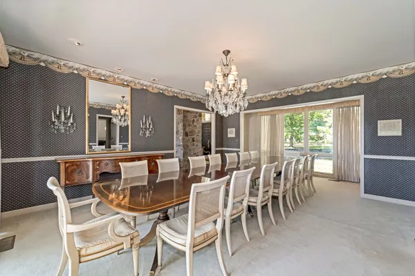 a view of a dining room with furniture and chandelier