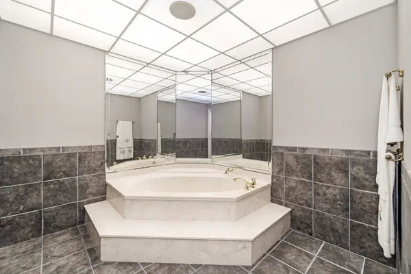 a large white tub sitting in a bathroom