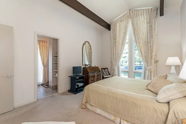 a bedroom with double bed and a window