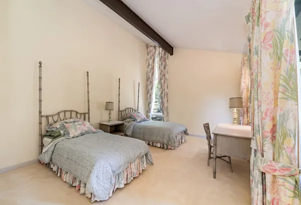 a bedroom with two beds and a table