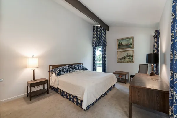 a bedroom with a bed and lamp