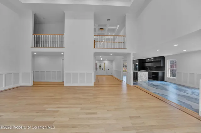 a view of staircase with white walls and railing