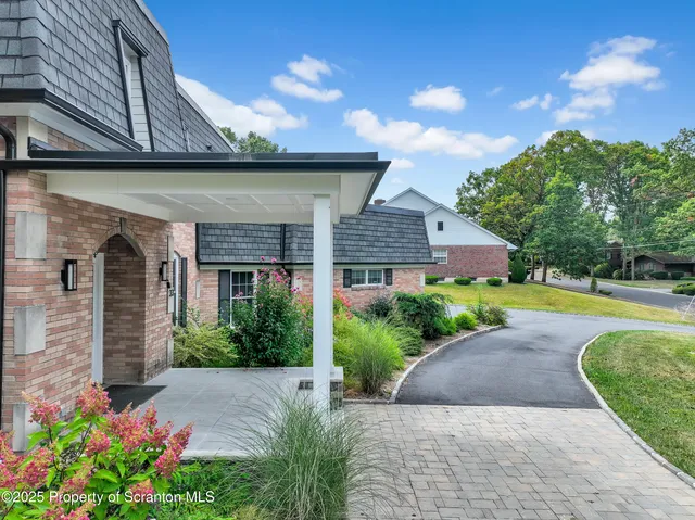a view of brick house with large windows