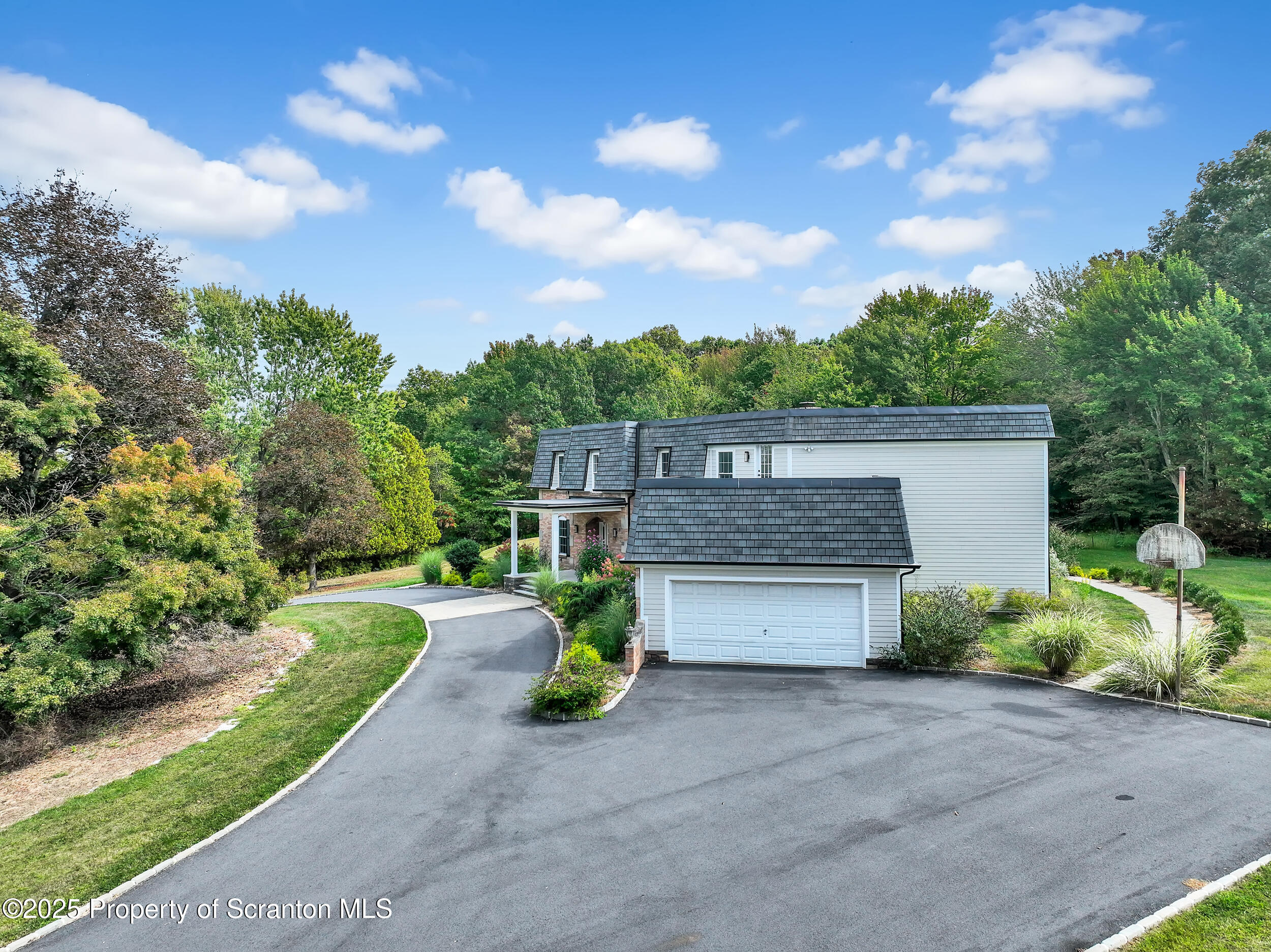 33 Fordham Road Wilkes Barre, PA 18702 - Photo 7 of 84 a front view of a house with a yard and garage