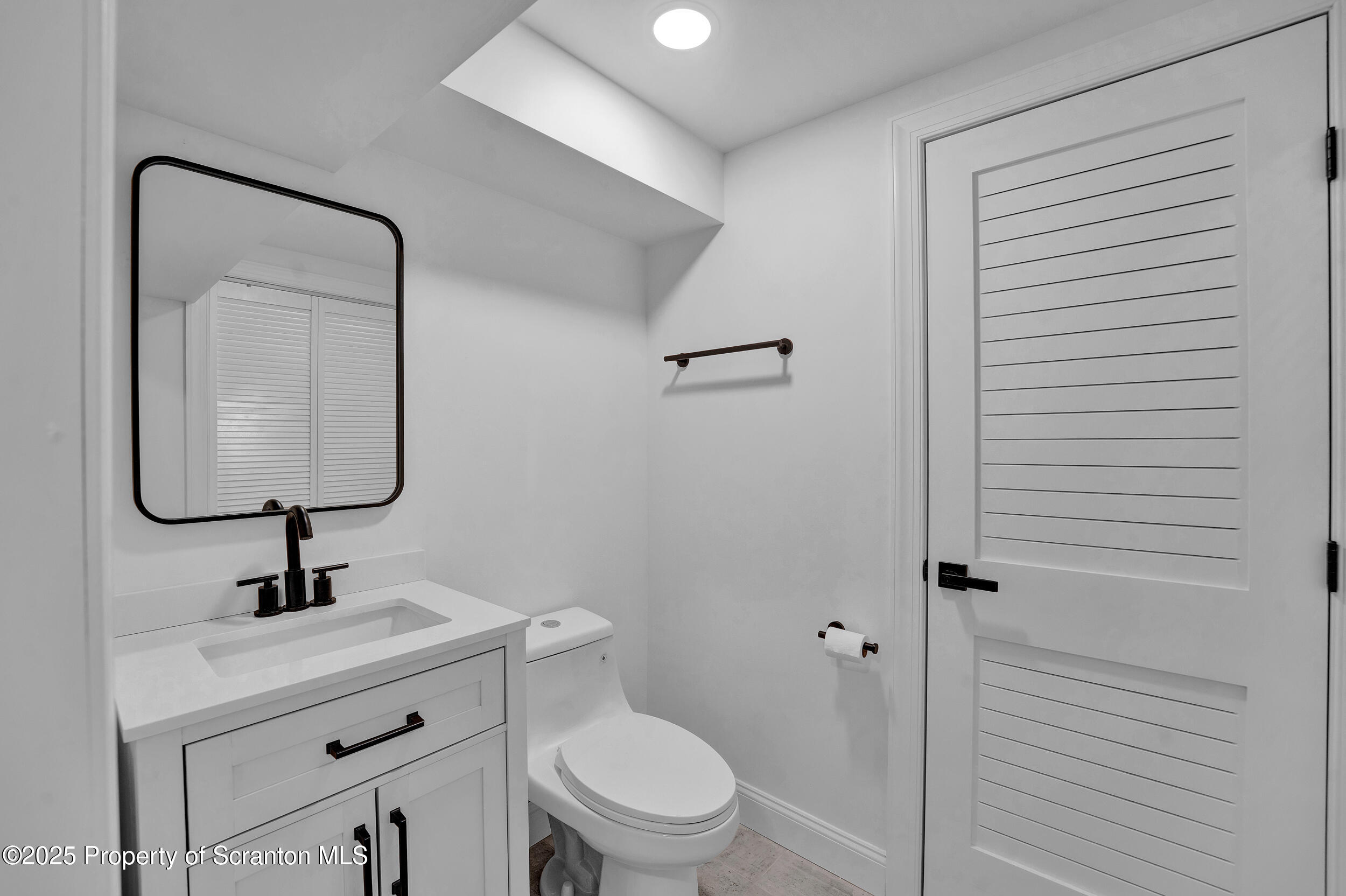 33 Fordham Road Wilkes Barre, PA 18702 - Photo 74 of 84 a bathroom with a toilet a sink and mirror