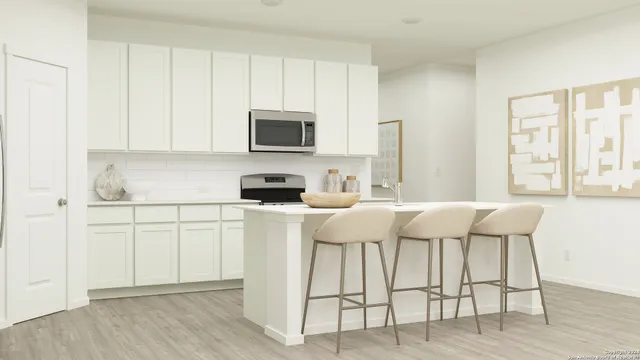 a kitchen with a table chairs refrigerator and microwave