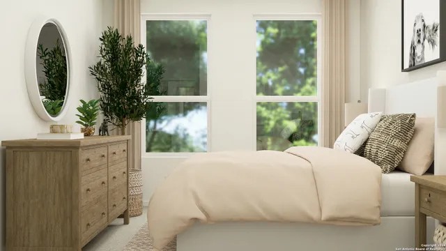 a bedroom with a bed mirror and window