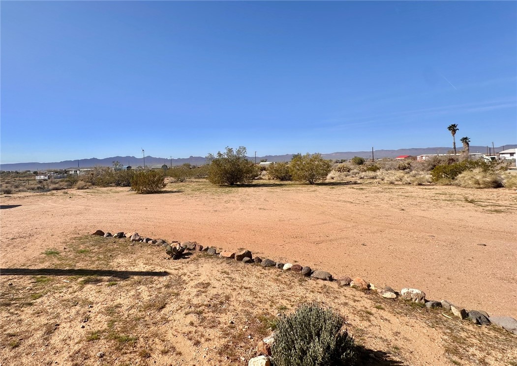 3309 Bacobi Road Golden Valley, AZ 86413 - Photo 9 of 31 View of yard featuring a mountain view, a desert view, and a view of rural / pastoral area