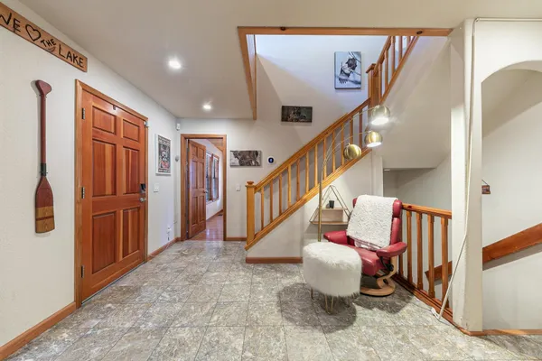 a bedroom with a bed and a large window with outer view