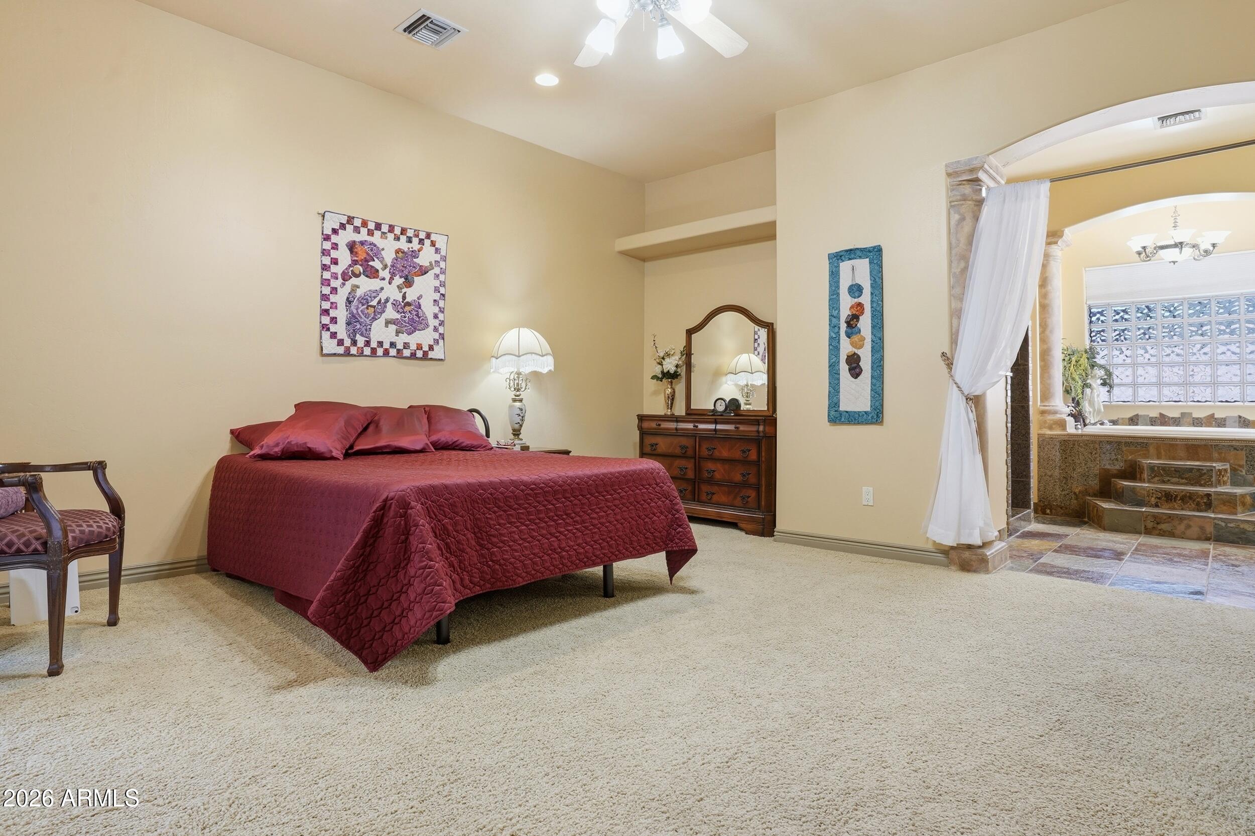 6334 East Albany Street Mesa, AZ 85205 - Photo 25 of 72 a spacious bedroom with a bed and a cabinets