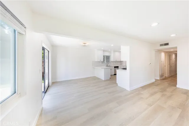 a view of a kitchen with a sink and cabinets