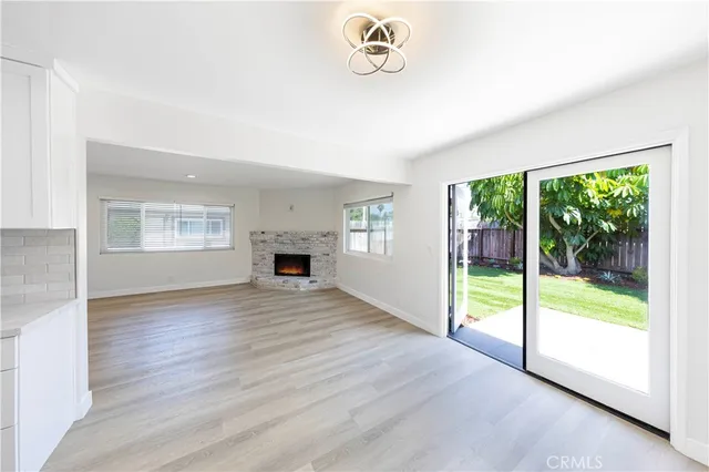 a view of empty room with wooden floor and fireplace