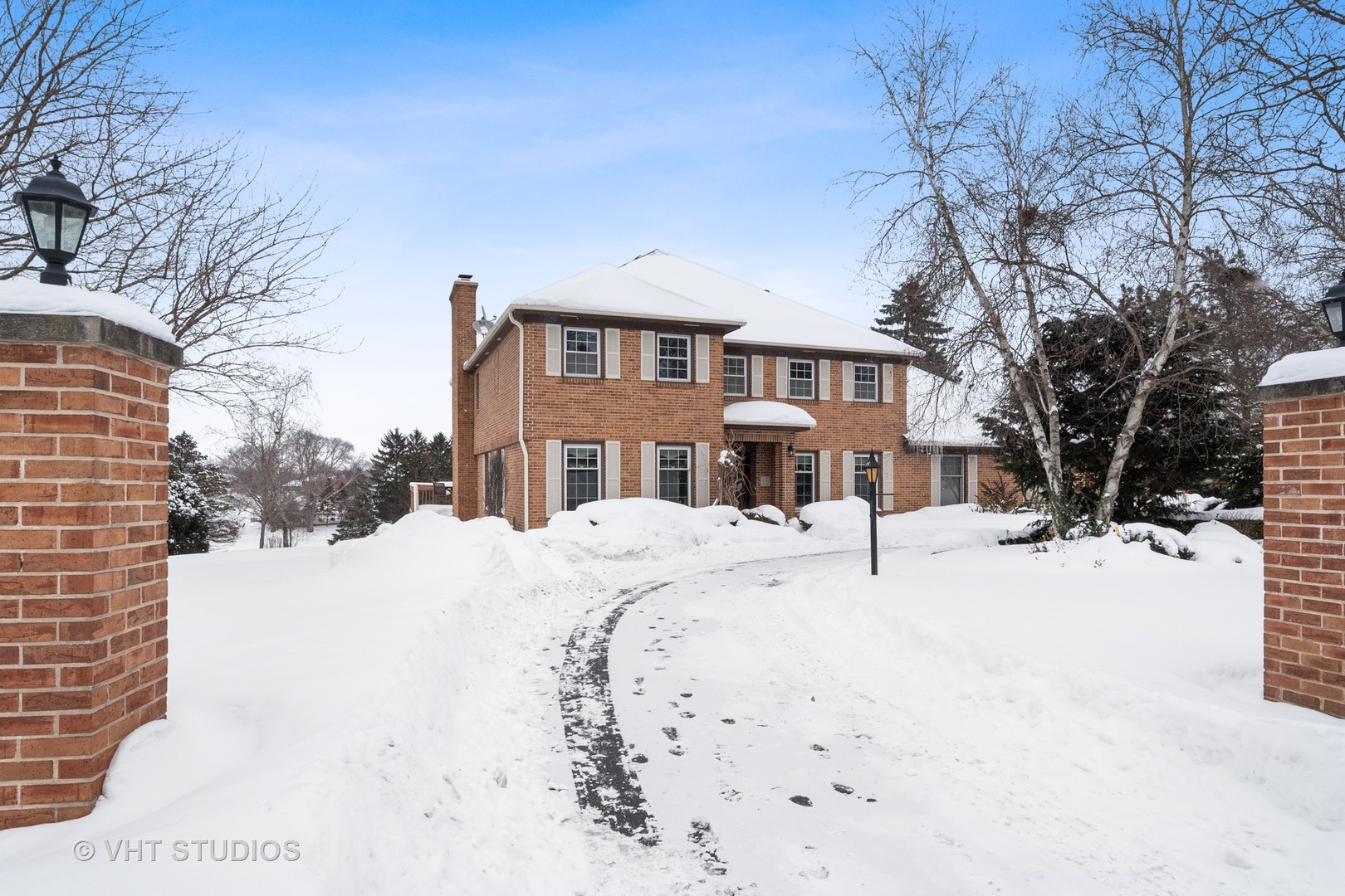 1406 Dunheath Drive Inverness, IL 60010 - Photo 1 of 27 a view of a white house with a snow in the background