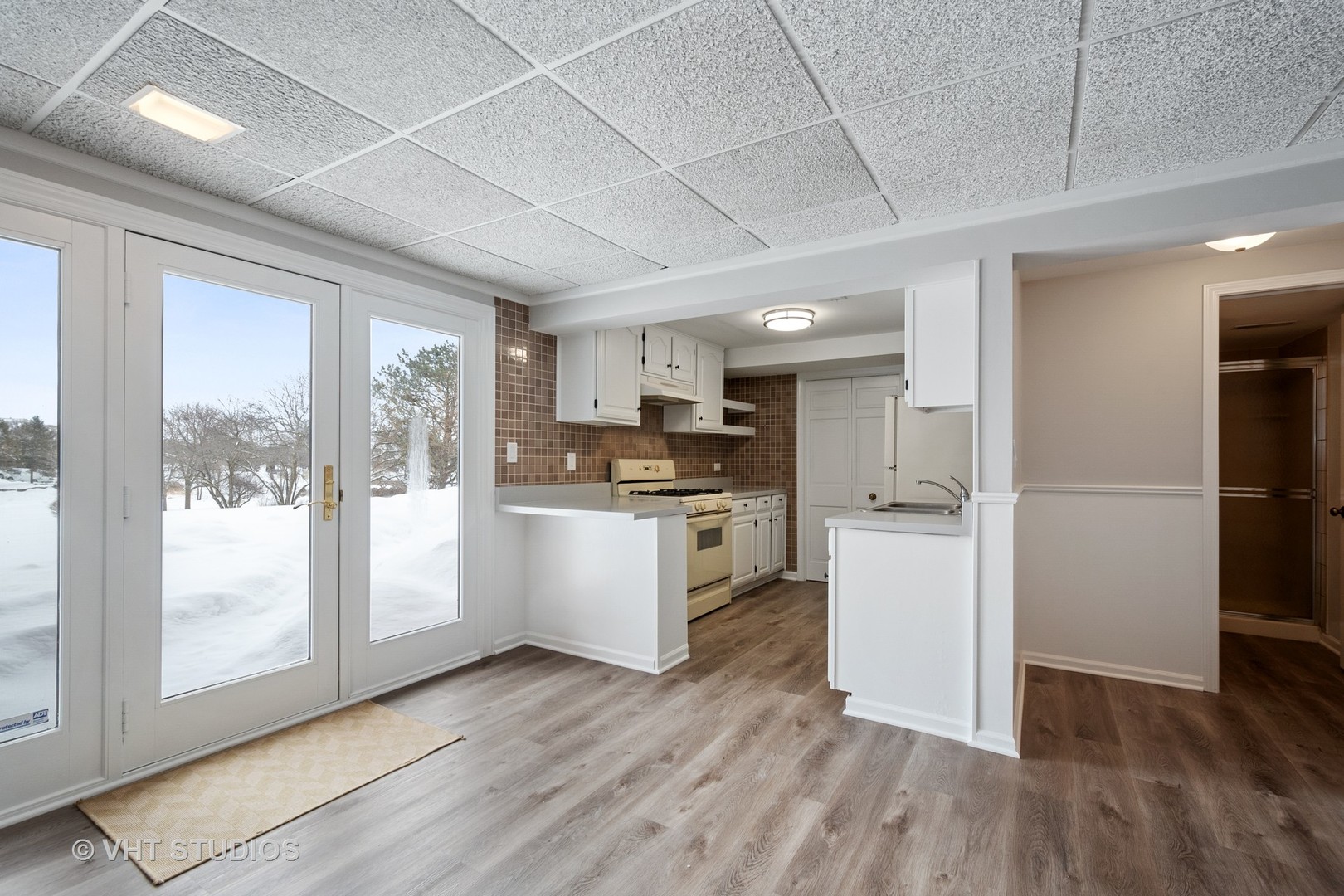 1406 Dunheath Drive Inverness, IL 60010 - Photo 19 of 27 a kitchen with white cabinets and wooden floor