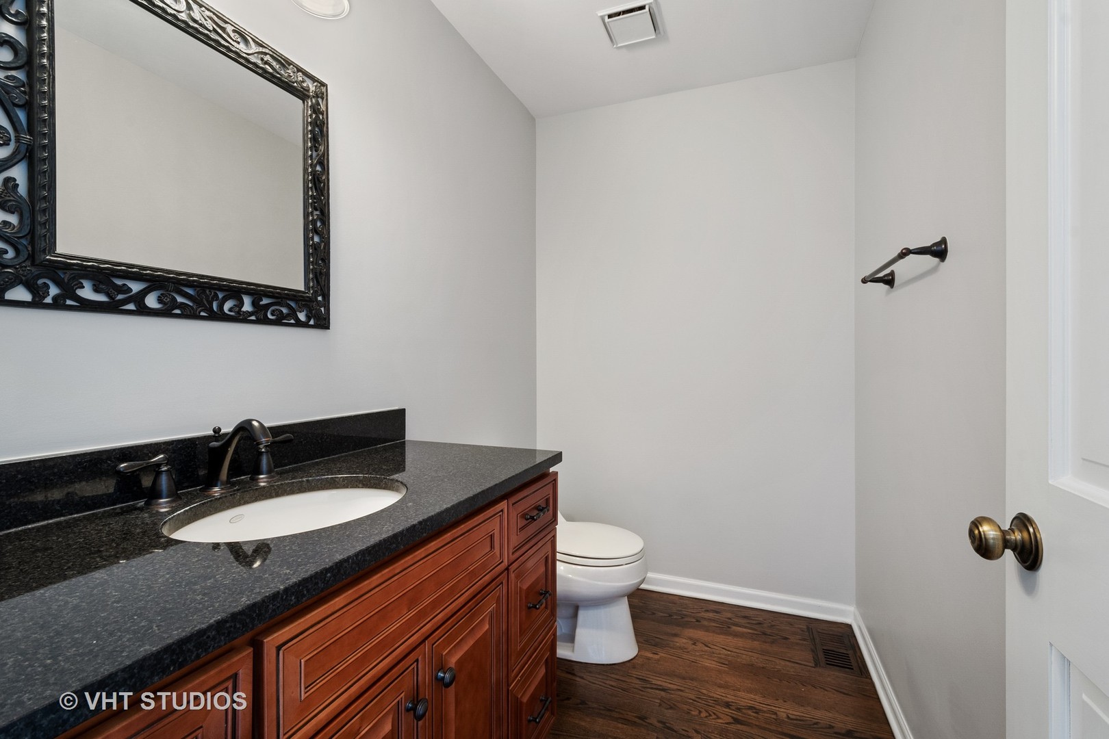 1406 Dunheath Drive Inverness, IL 60010 - Photo 21 of 27 a bathroom with a granite countertop sink toilet and a mirror