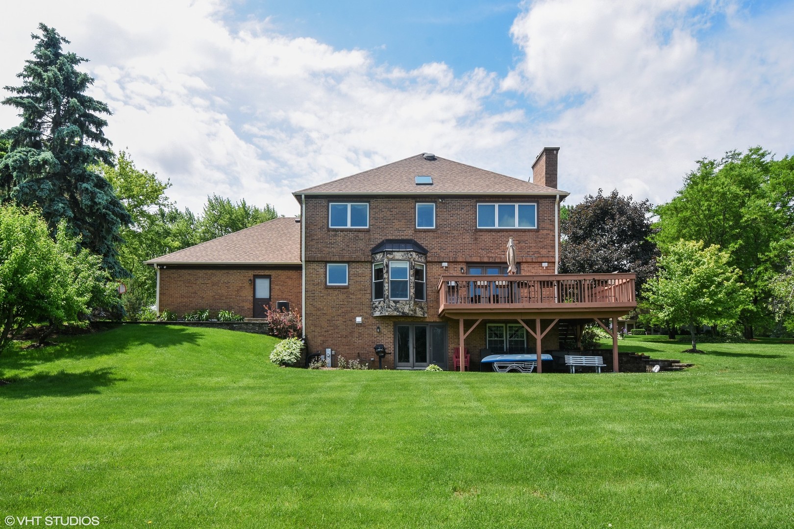 1406 Dunheath Drive Inverness, IL 60010 - Photo 22 of 27 a view of a house with a big yard potted plants and large trees