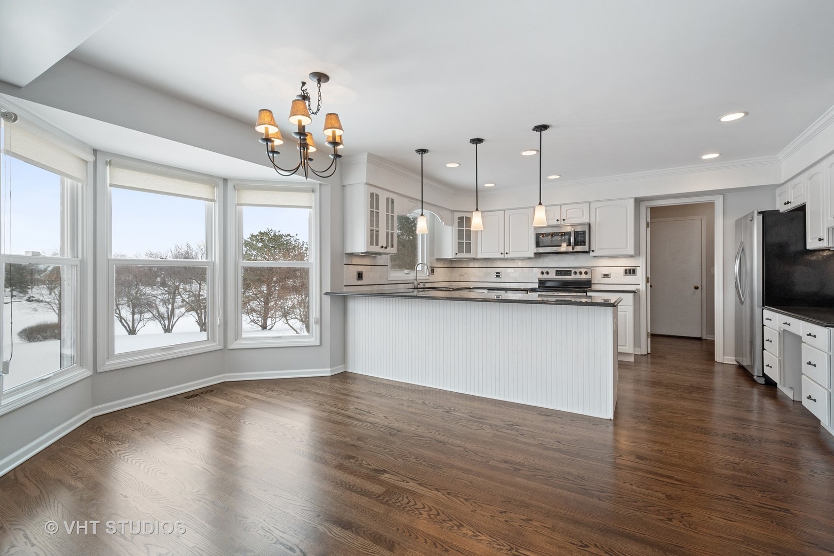 1406 Dunheath Drive Inverness, IL 60010 - Photo 6 of 27 a kitchen with stainless steel appliances granite countertop a refrigerator a stove top oven a sink dishwasher and white cabinets with wooden floor