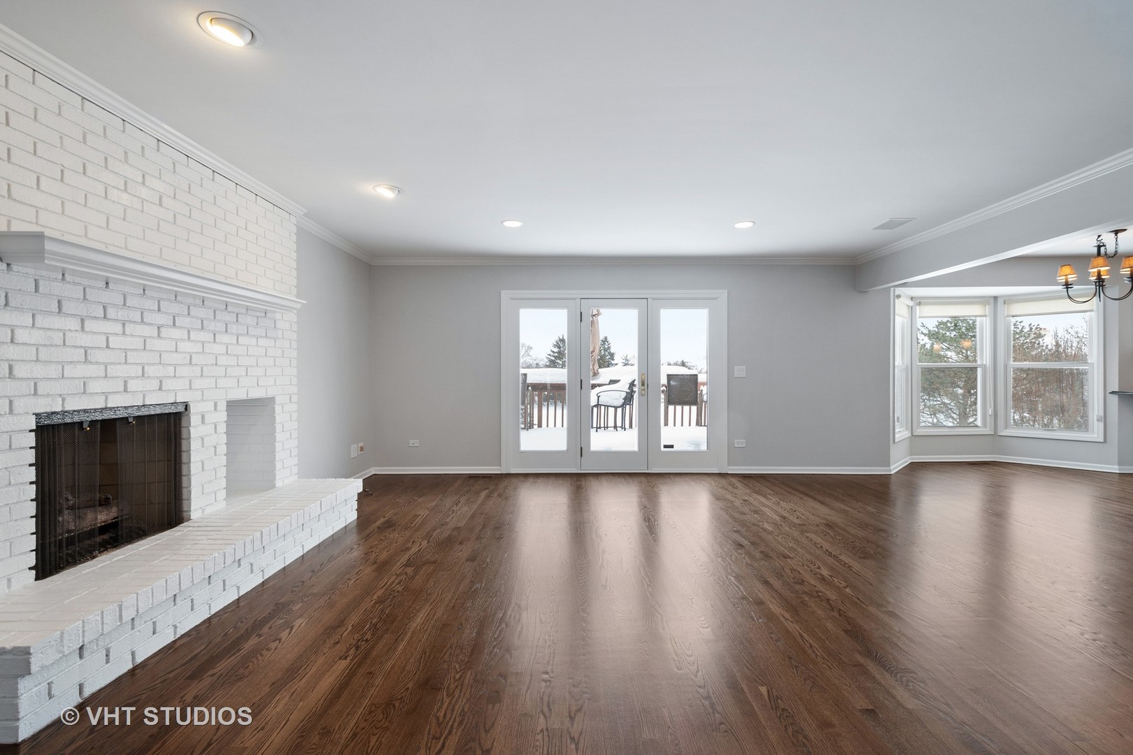 1406 Dunheath Drive Inverness, IL 60010 - Photo 10 of 27 a view of an empty room with wooden floor and a fireplace