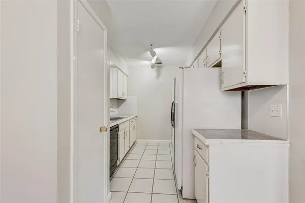 a kitchen with a sink appliances and cabinets