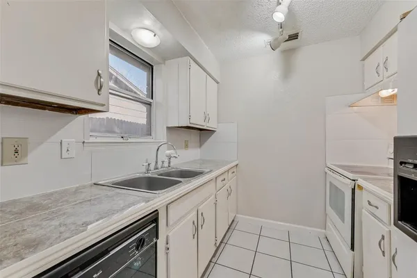 a kitchen with a sink stove and cabinets