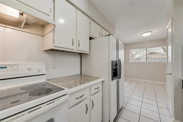 a kitchen with granite countertop a sink and a stove top oven