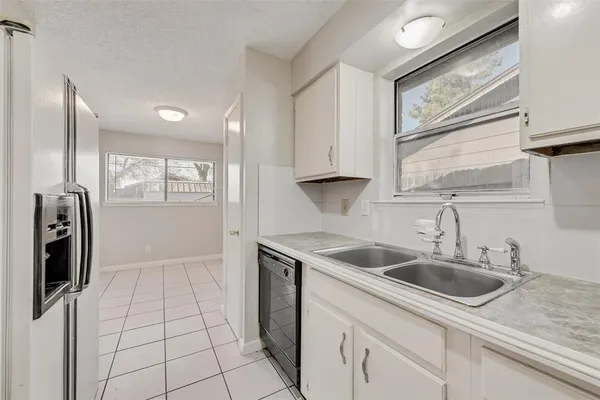 a kitchen with a sink cabinets and window