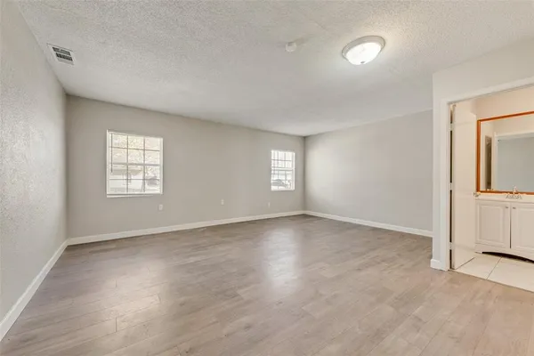an empty room with windows and closet