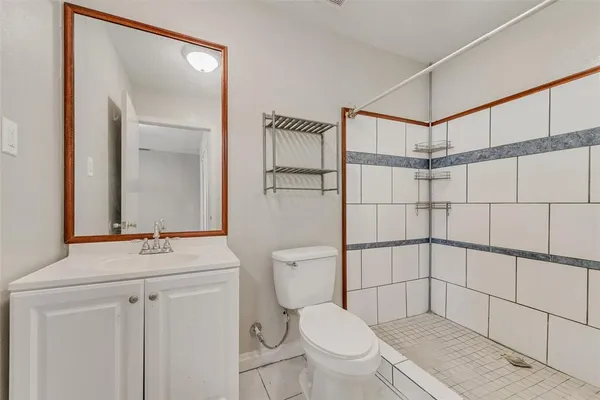 a bathroom with a sink a toilet a shower and a mirror