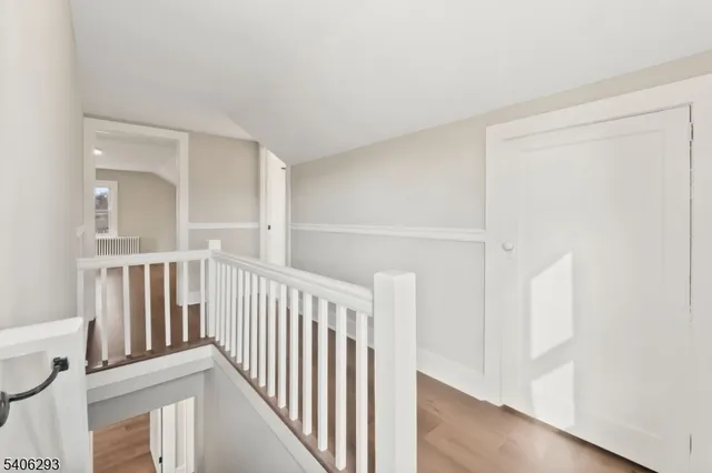 a view of staircase with white walls and a window