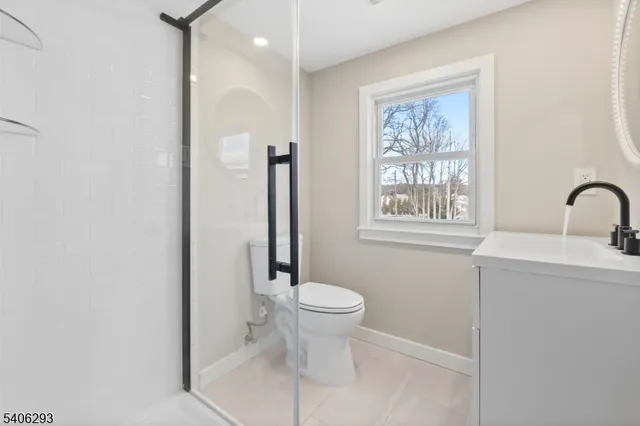 a bathroom with a toilet sink and a window