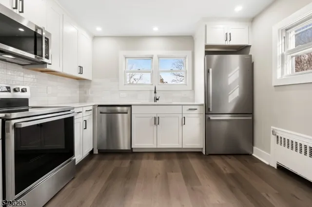 a kitchen with stainless steel appliances a refrigerator stove and microwave