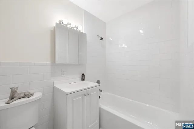 a bathroom with a sink a toilet and bathtub