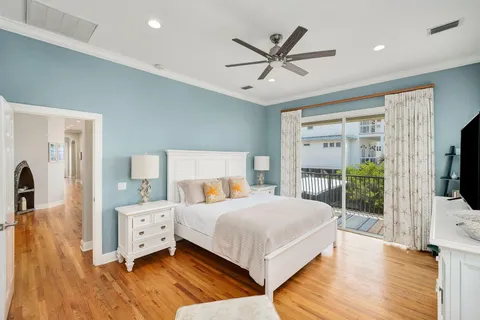a bedroom with a large bed and a flat tv screen on dresser