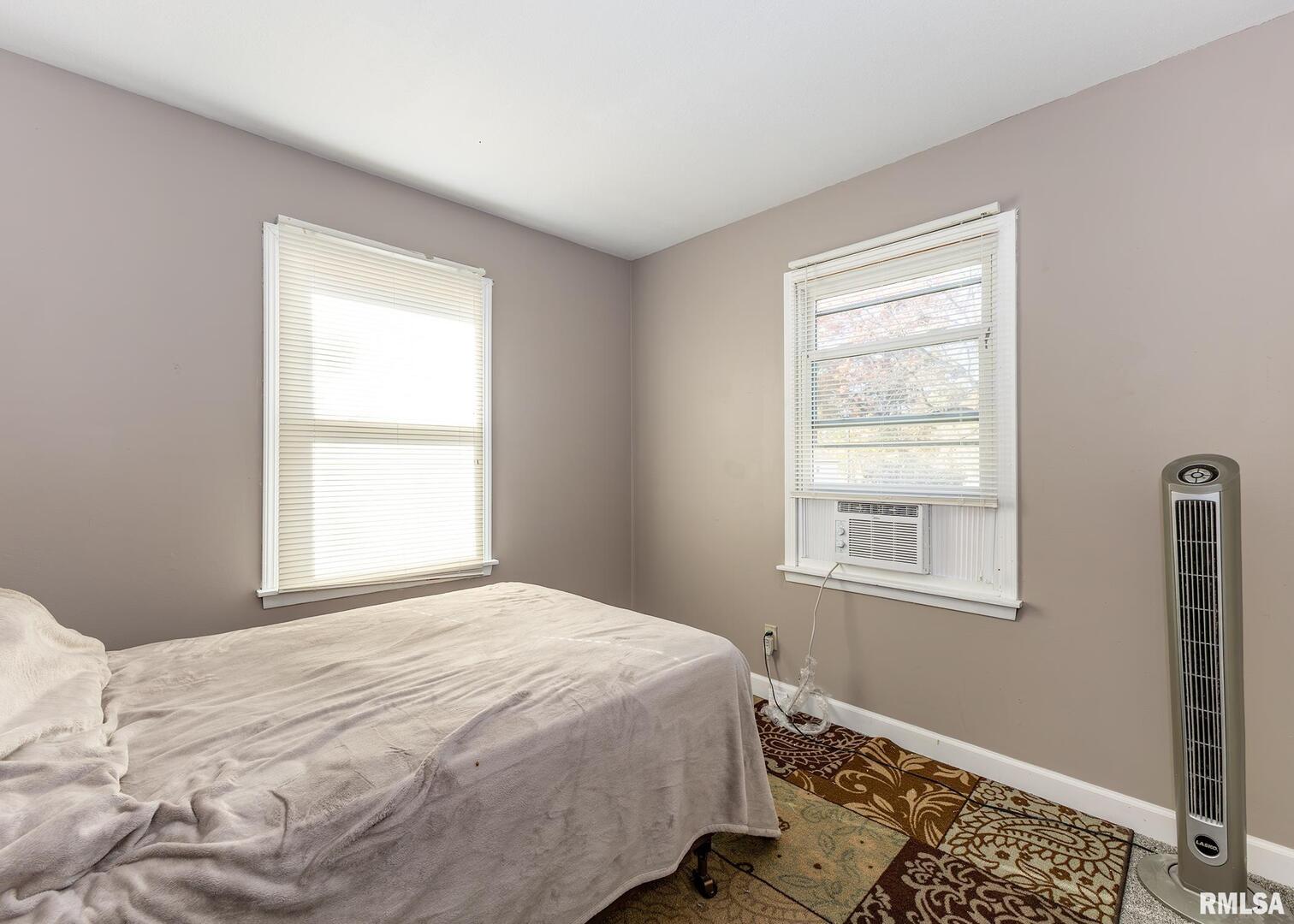 1430 4th Street Camanche, IA 52730 - Photo 11 of 22 a bedroom with a bed and a window