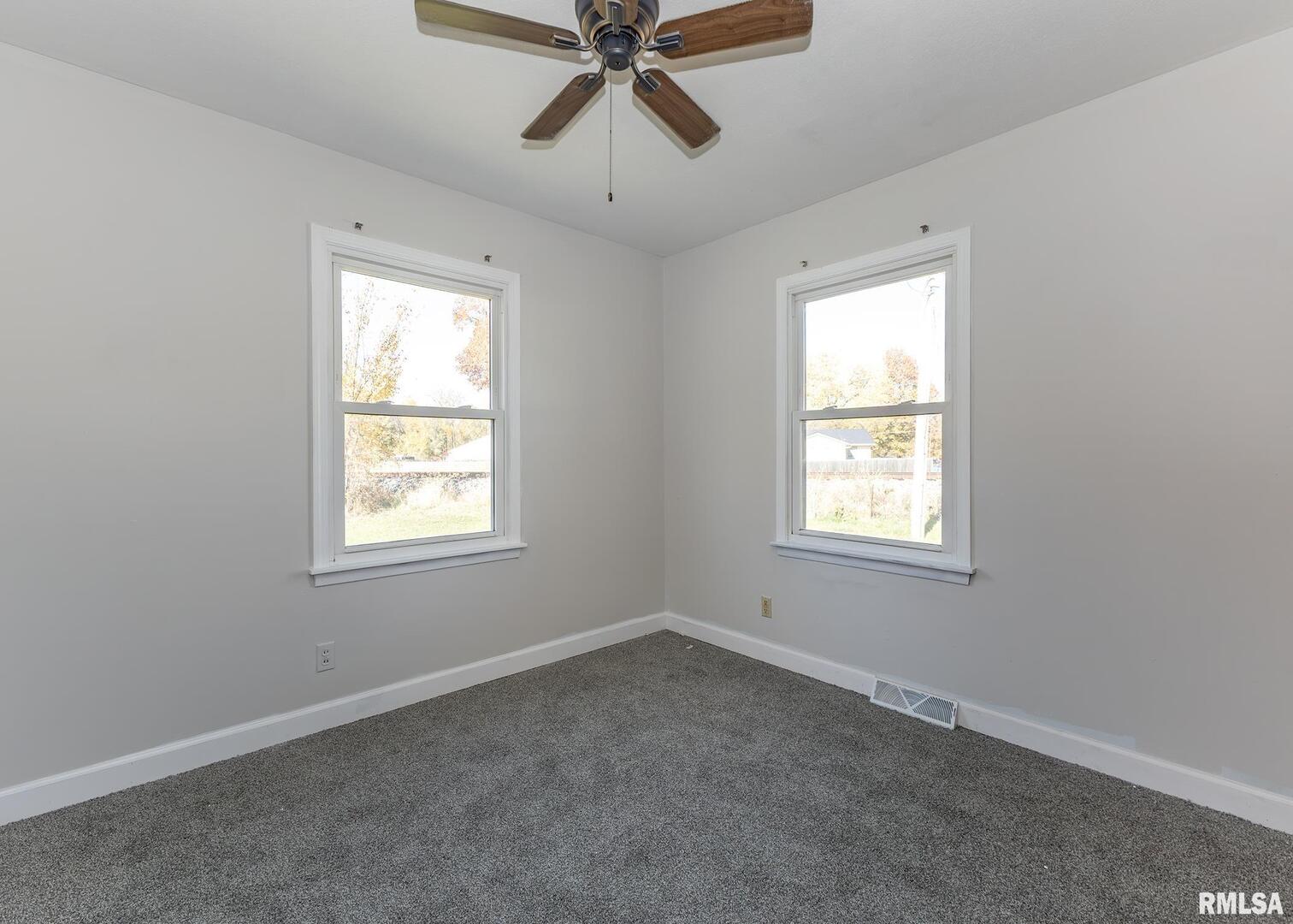 1430 4th Street Camanche, IA 52730 - Photo 13 of 22 an empty room with a window and a fan