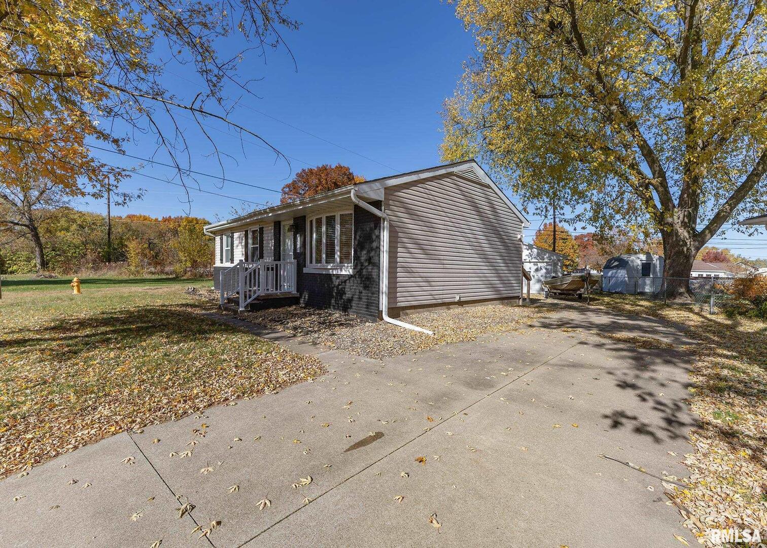 1430 4th Street Camanche, IA 52730 - Photo 2 of 22 a view of a house with a yard