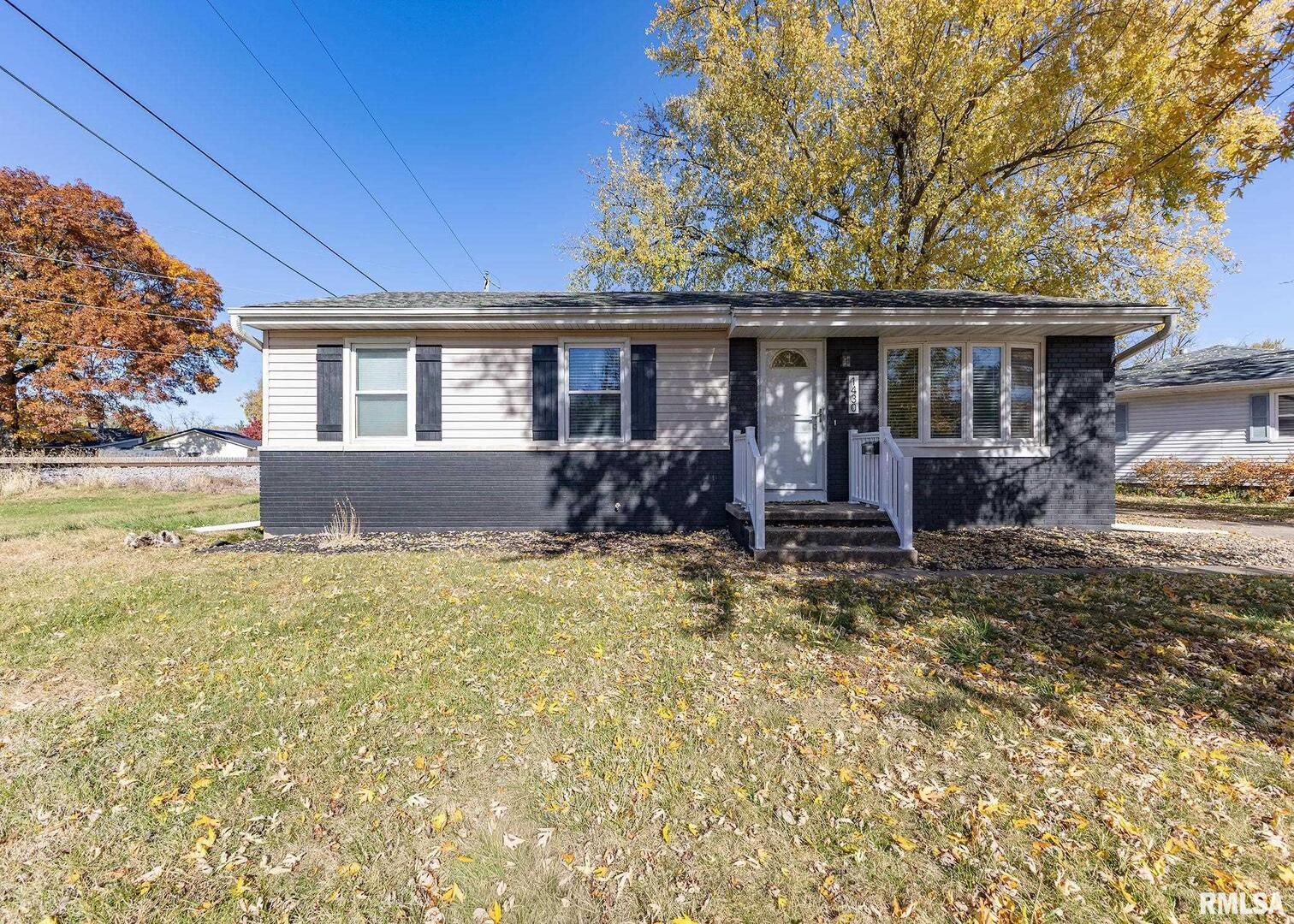 1430 4th Street Camanche, IA 52730 - Photo 3 of 22 a front view of a house with a yard