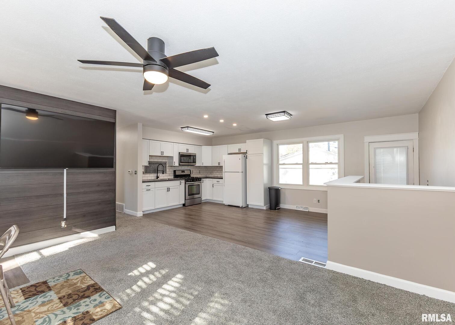 1430 4th Street Camanche, IA 52730 - Photo 5 of 22 a view of a livingroom with a ceiling fan and window