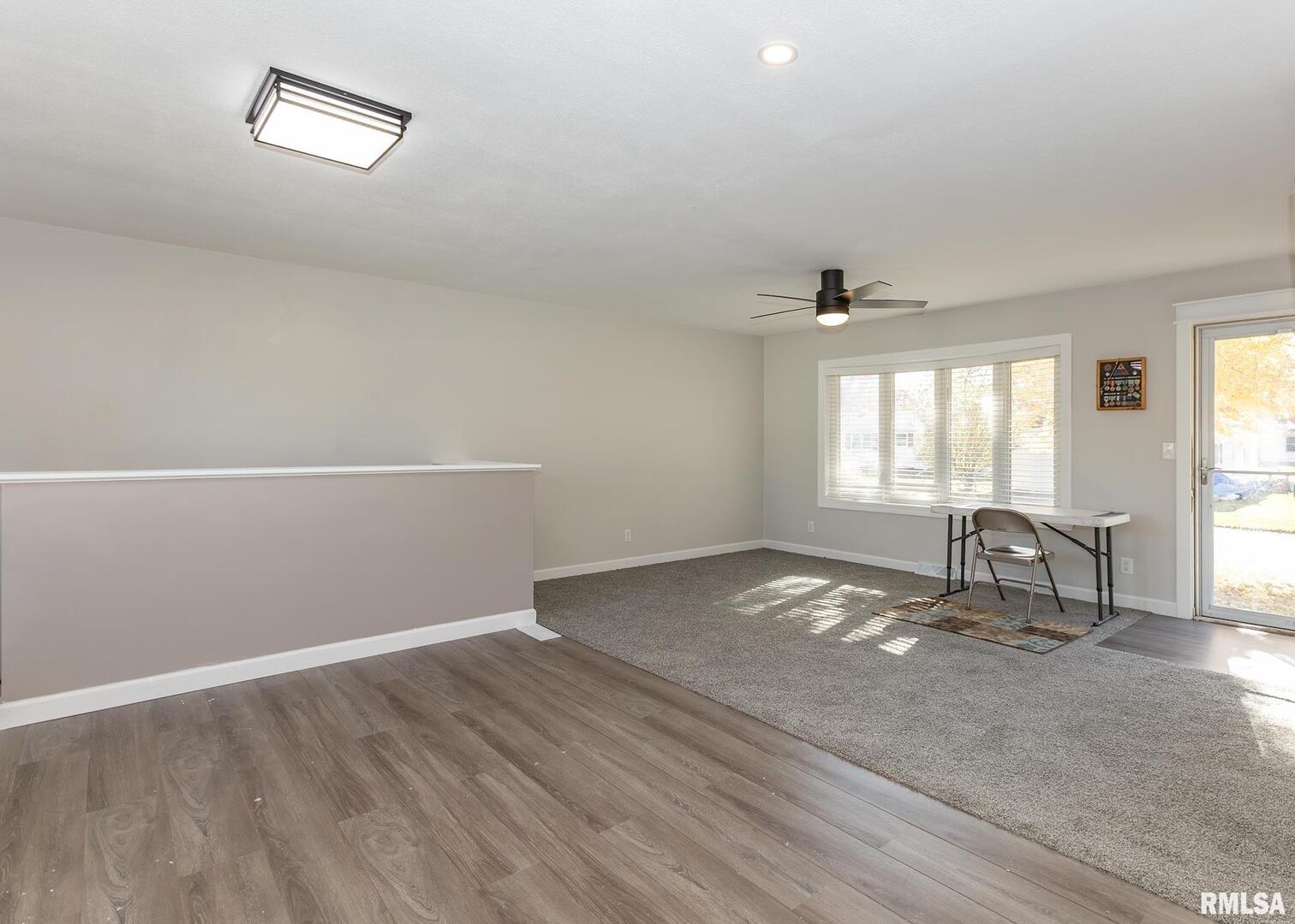 1430 4th Street Camanche, IA 52730 - Photo 6 of 22 an empty room with wooden floor and windows