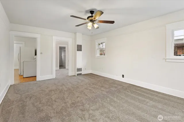 a view of an empty room with a ceiling fan