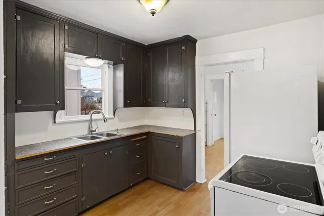 a kitchen with a sink stove and refrigerator