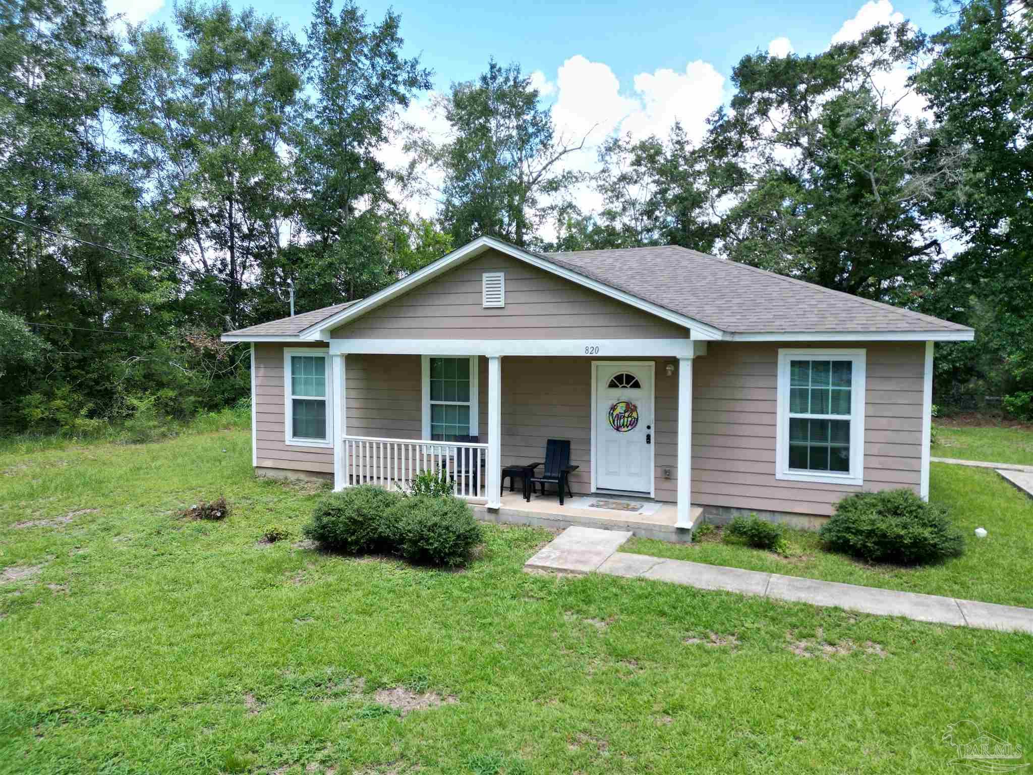 a front view of a house with a garden and porch