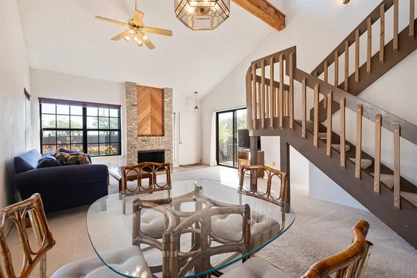 a living room with fireplace furniture and a large window