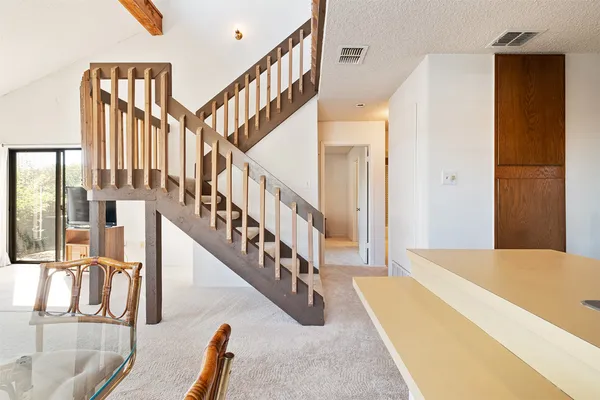 a view of staircase and living room with wooden floor