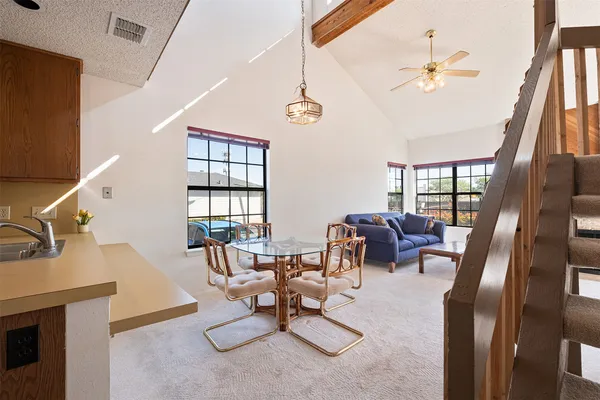 a living room with furniture fireplace and a large window