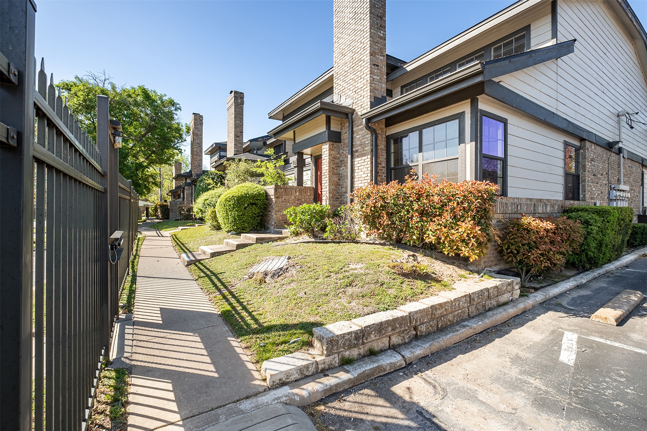 1748 Ohlen Road, Unit 16 Austin, TX 78757 - Photo 2 of 38 a front view of a house with a yard