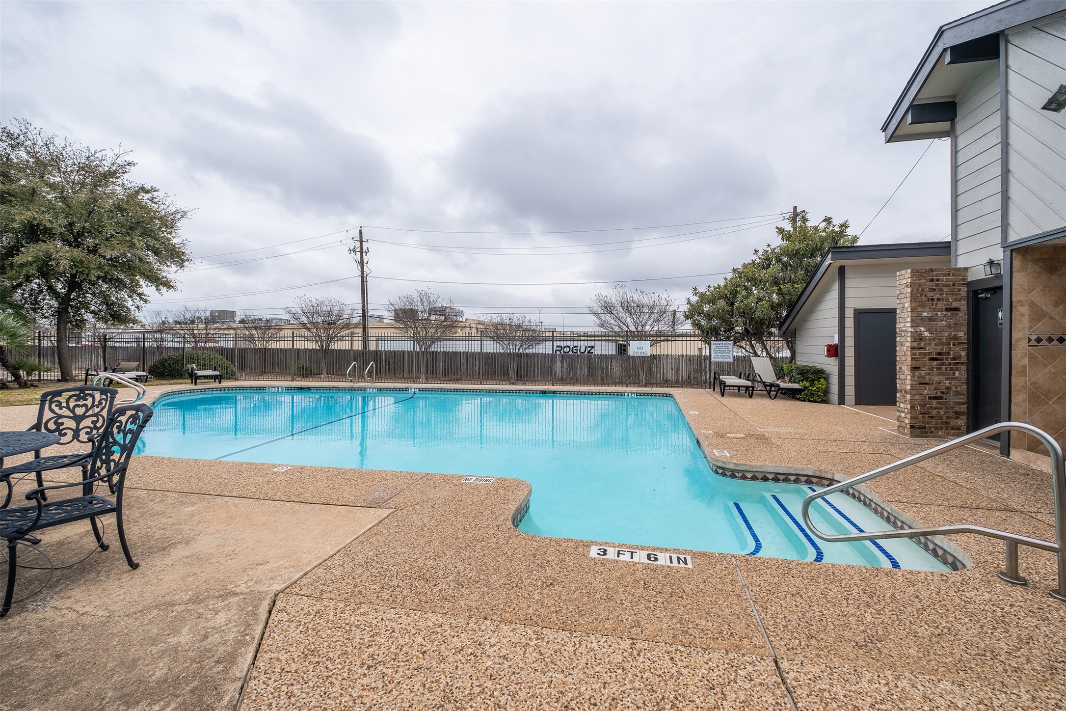 1748 Ohlen Road, Unit 16 Austin, TX 78757 - Photo 37 of 38 a view of a swimming pool with a lounge chairs
