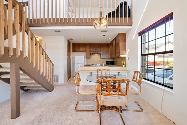 a view of a kitchen with furniture and staircase
