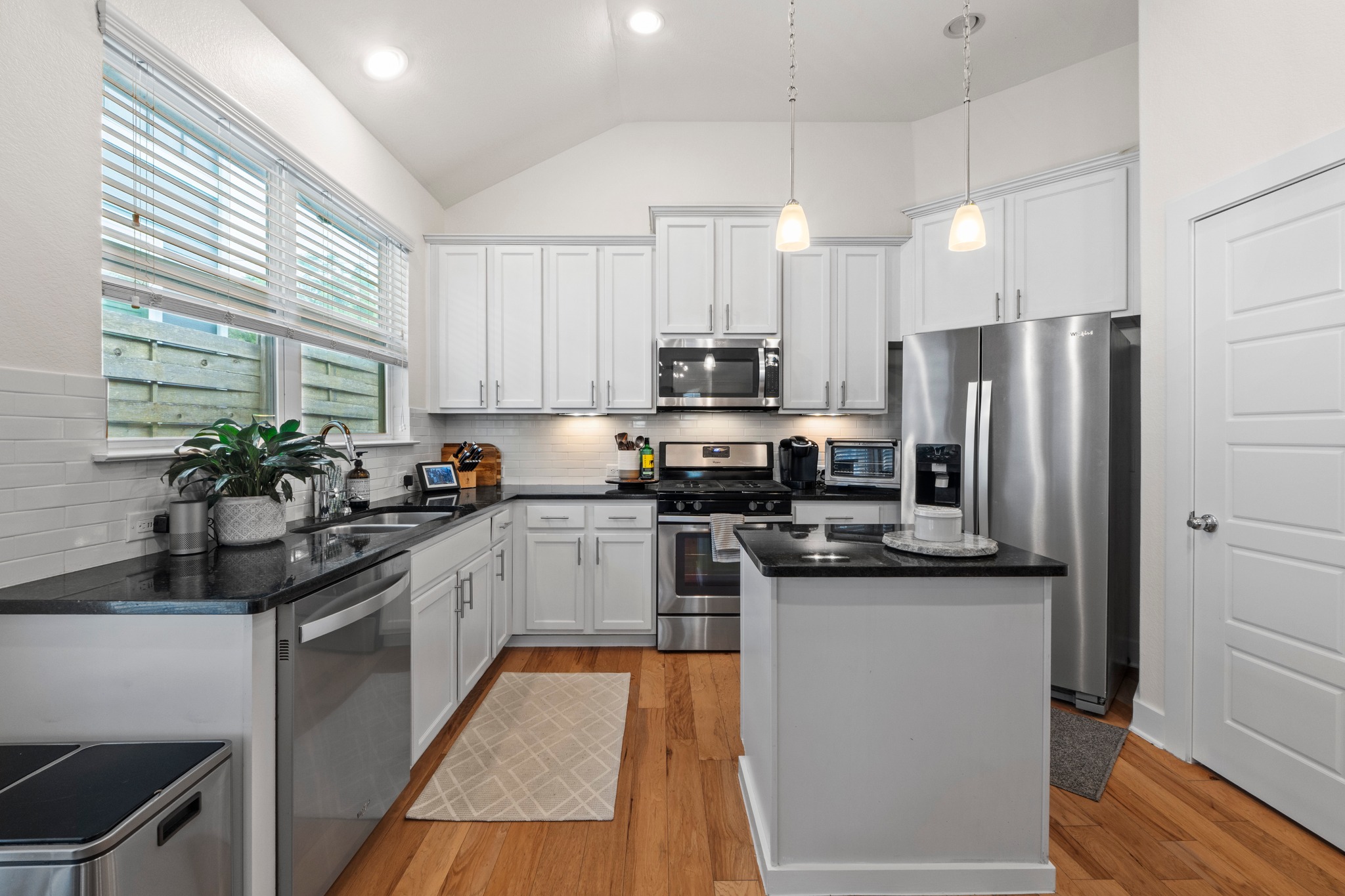 2100 Hermia Street, Unit 41 Austin, TX 78741 - Photo 6 of 22 a kitchen with stainless steel appliances a sink a stove a refrigerator cabinets and a counter top space