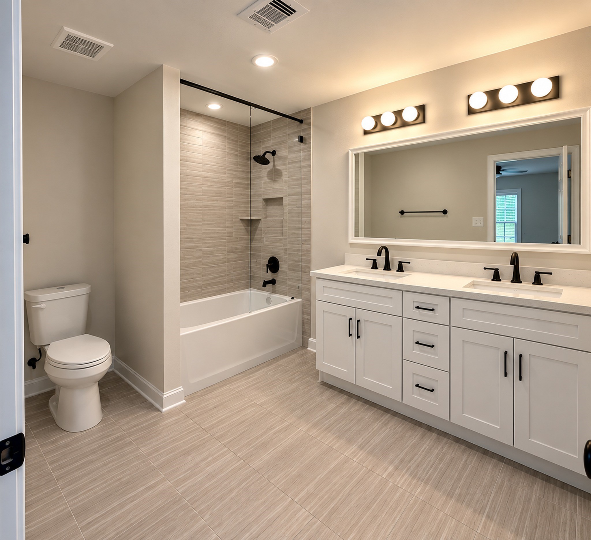 8828 Curry Road Houston, TX 77093 - Photo 8 of 15 Elegant bathroom featuring a modern double vanity with sleek black fixtures, a spacious bathtub with a glass enclosure, and stylish tile flooring.